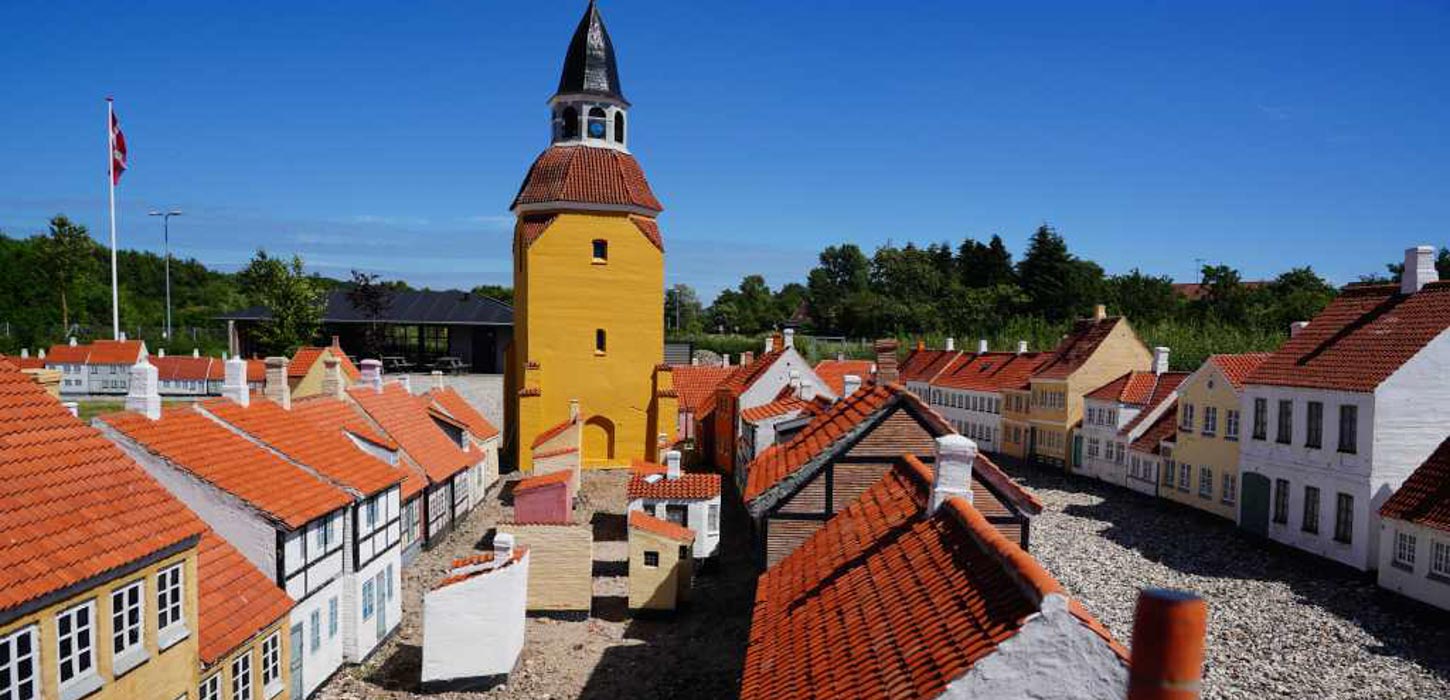 Et view ud over Faaborg Miniby med en masse små bindingsværkshuse og det karakteristiske gule klokketårn med det røde tegltag.