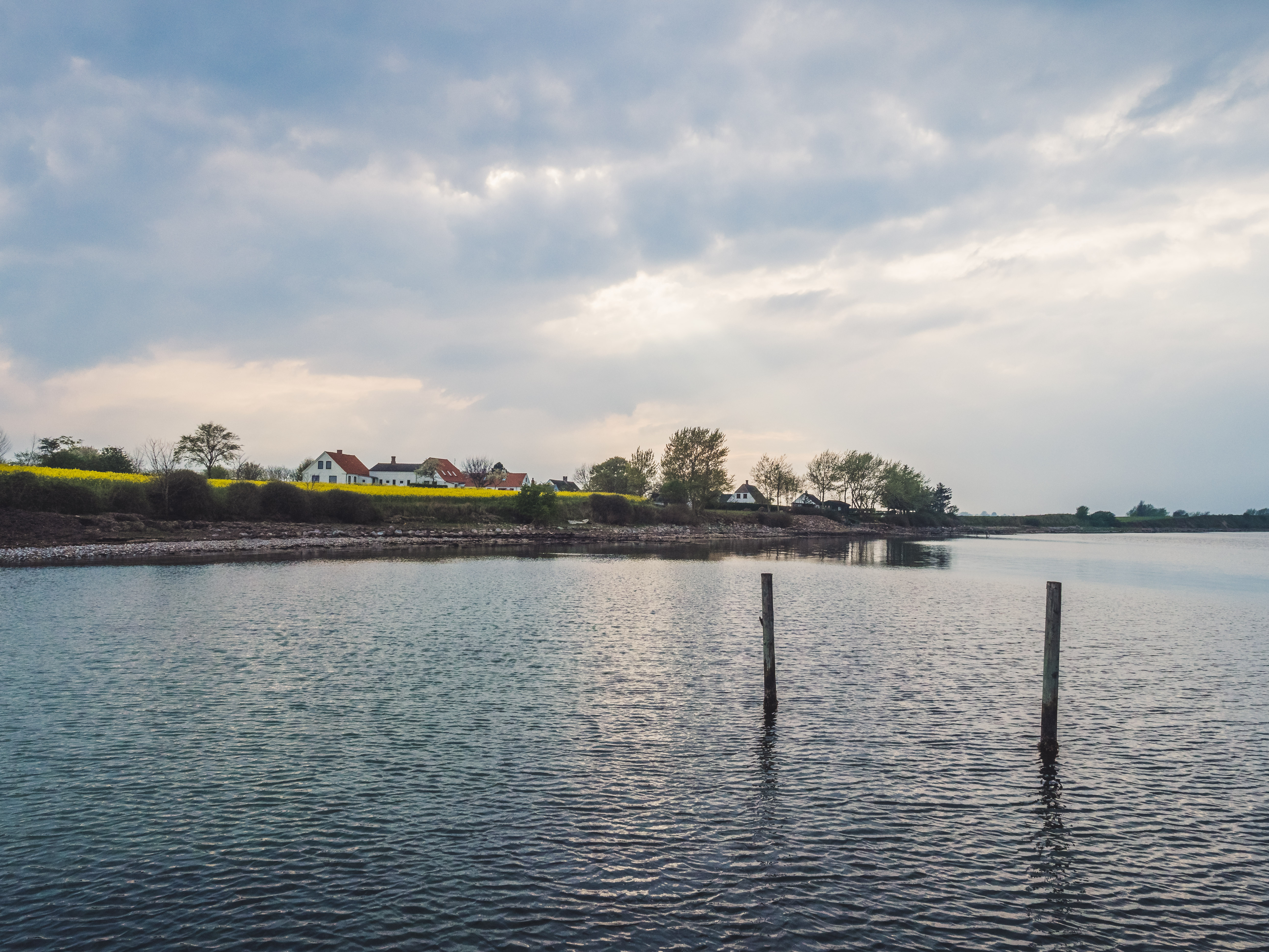 Avernakø with sun through the clouds, as seen from sea-level