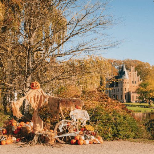 A halloween scarecrow in front of the old renaissance castle Egeskov on an autumn day