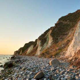 Stejl klint ud til sten og strand